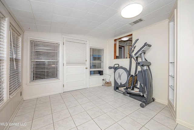 exercise room featuring light tile patterned flooring