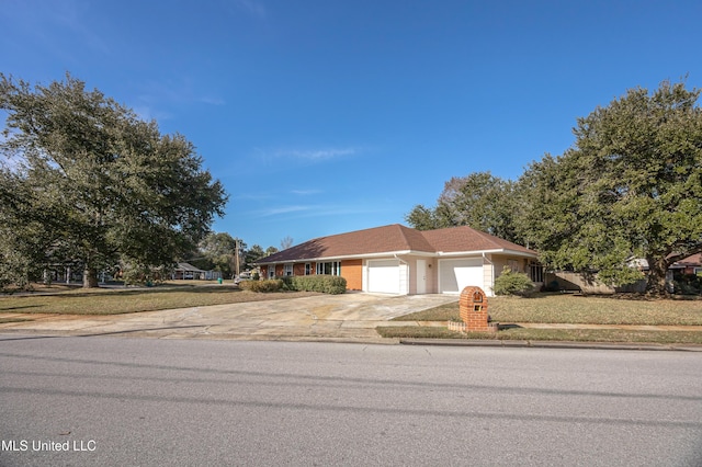 view of front facade with a garage and a front lawn