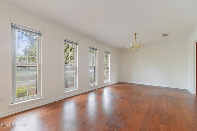 43 Greenbriar Dr, Gulfport, MS 39507 - unfurnished room featuring an inviting chandelier, crown molding, a healthy amount of sunlight, and wood finished floors