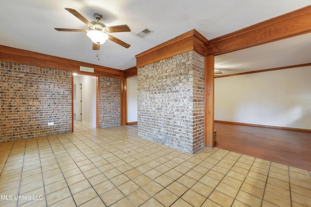 43 Greenbriar Dr, Gulfport, MS 39507 - spare room featuring light tile patterned flooring, brick wall, visible vents, and ceiling fan
