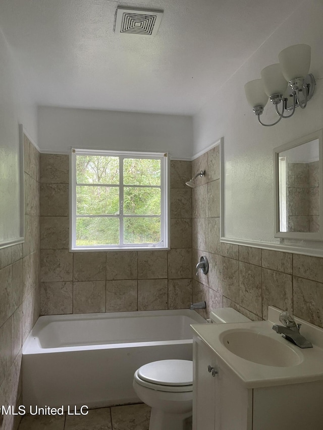 2938 Oak Forest Dr, Jackson, MS 39212 - bathroom featuring vanity, tile walls, washtub / shower combination, tile patterned flooring, and a chandelier