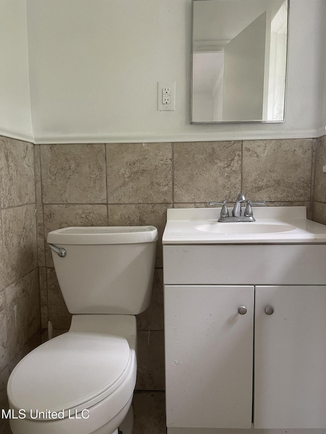 2938 Oak Forest Dr, Jackson, MS 39212 - bathroom with vanity, tile walls, and wainscoting