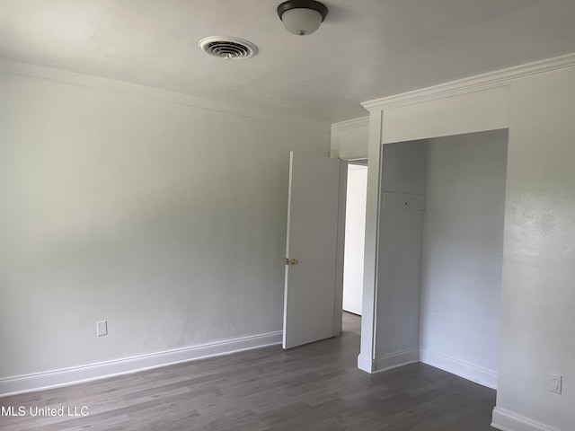 2938 Oak Forest Dr, Jackson, MS 39212 - unfurnished bedroom with dark wood-style floors and baseboards