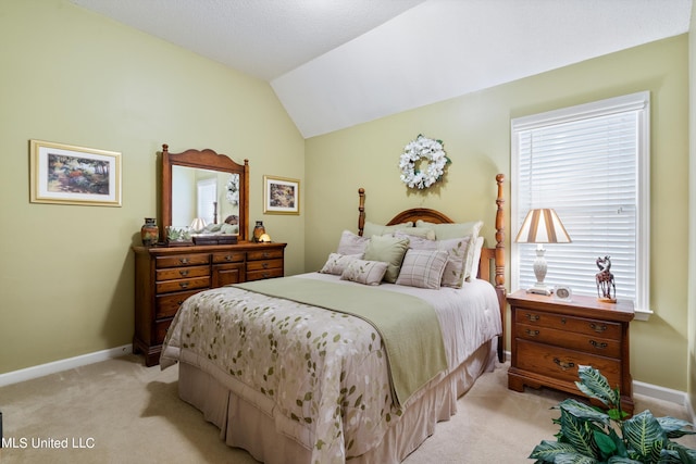 carpeted bedroom with lofted ceiling