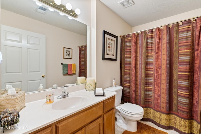 bathroom featuring toilet, a textured ceiling, and vanity