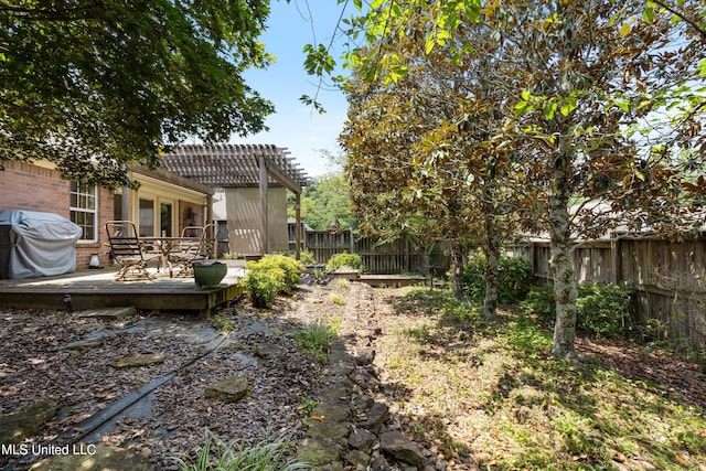 view of yard with a deck and a pergola