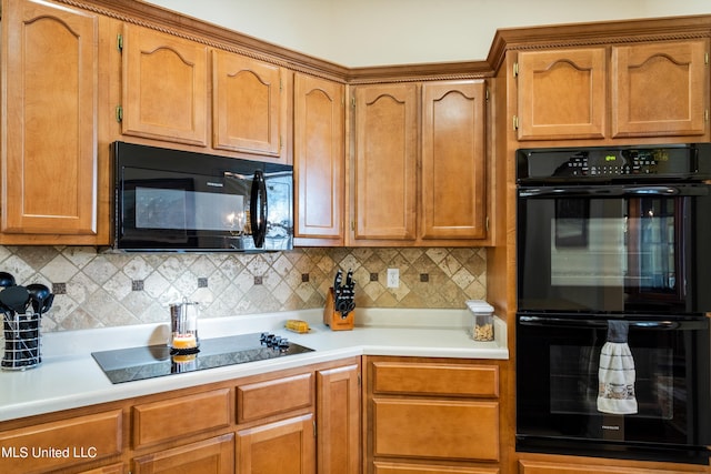 kitchen with backsplash and black appliances