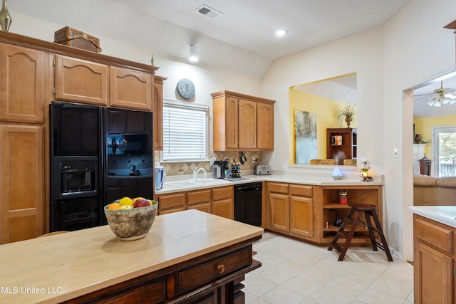 kitchen with lofted ceiling, tasteful backsplash, light tile patterned floors, ceiling fan, and black appliances