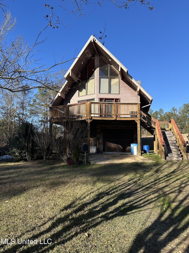 rear view of property featuring a deck and a yard