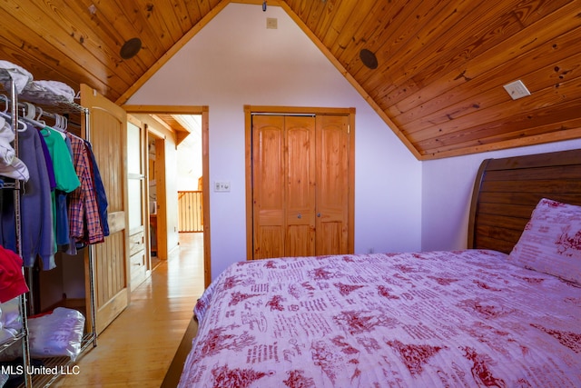 bedroom with lofted ceiling, wooden ceiling, a closet, and light wood-type flooring