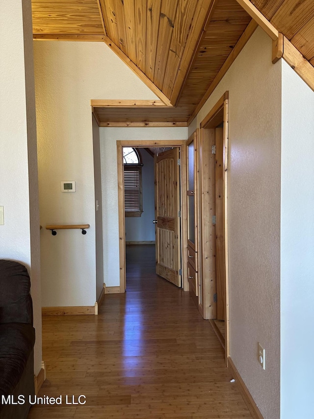 hallway featuring vaulted ceiling, wooden ceiling, and dark hardwood / wood-style floors