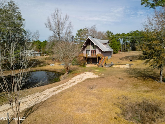 view of front of house with a front lawn and a deck