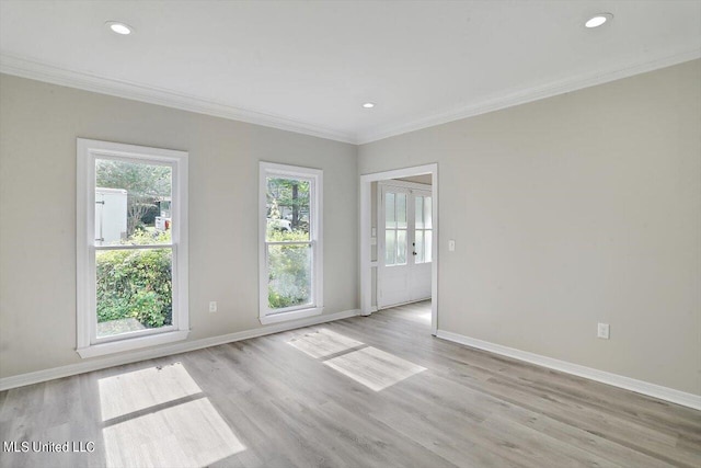 unfurnished room with ornamental molding, french doors, and light wood-type flooring