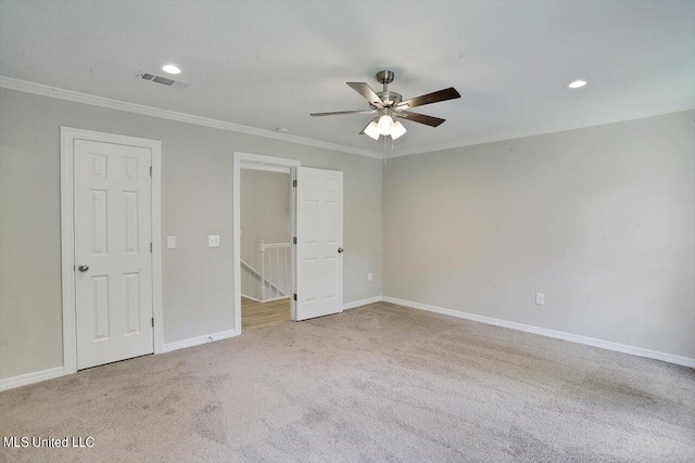 unfurnished bedroom with crown molding, light carpet, and ceiling fan