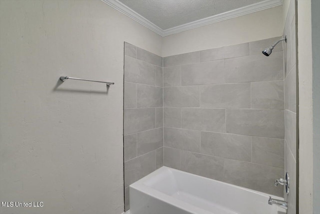 bathroom with ornamental molding, tiled shower / bath combo, and a textured ceiling