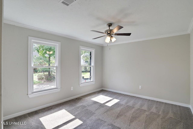 carpeted empty room featuring ceiling fan, a healthy amount of sunlight, and ornamental molding