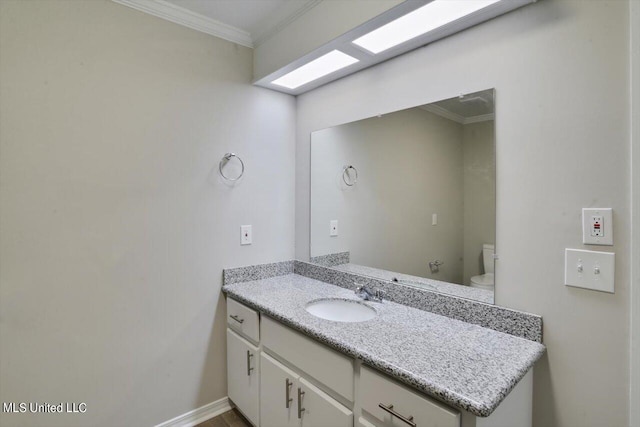 bathroom featuring vanity, ornamental molding, and toilet