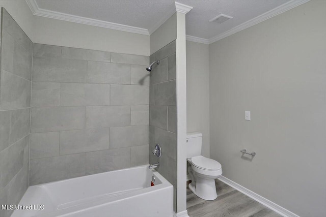 bathroom featuring toilet, tiled shower / bath combo, hardwood / wood-style flooring, and ornamental molding