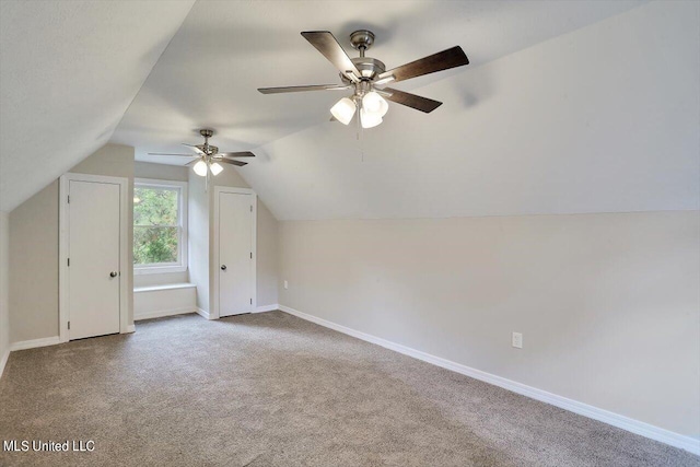 additional living space featuring ceiling fan, light colored carpet, and vaulted ceiling