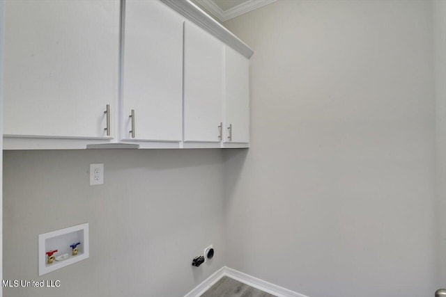 laundry room with crown molding, hardwood / wood-style flooring, washer hookup, and cabinets