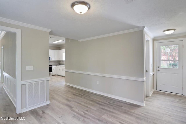 entrance foyer with crown molding, a textured ceiling, and light wood-type flooring