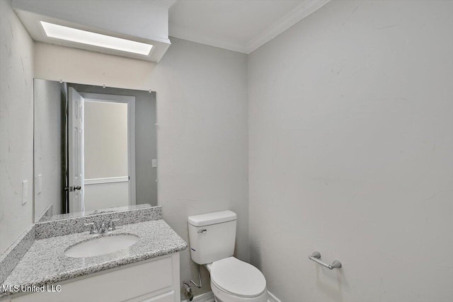 bathroom featuring toilet, ornamental molding, and vanity