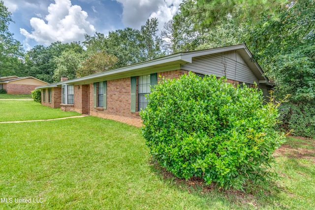 view of property exterior with a yard