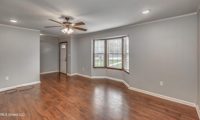 empty room featuring crown molding, dark hardwood / wood-style floors, and ceiling fan