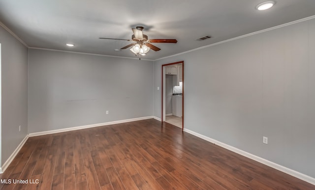 spare room featuring crown molding, dark hardwood / wood-style floors, and ceiling fan