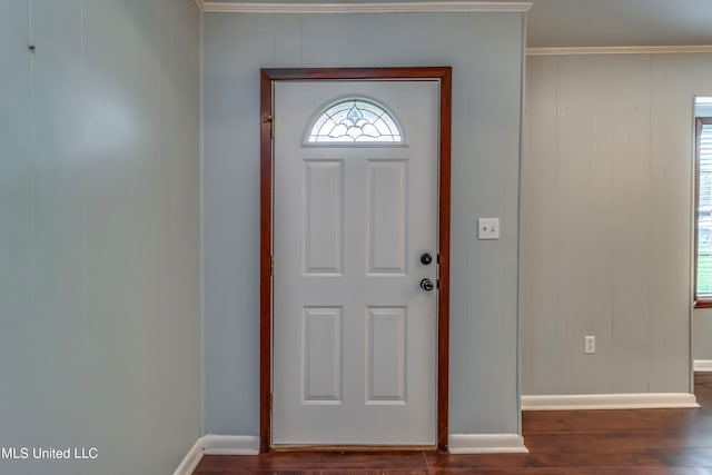 entrance foyer with dark wood-type flooring and crown molding