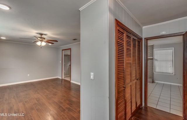 hall with ornamental molding and dark hardwood / wood-style floors