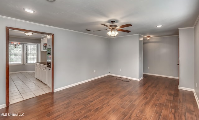 unfurnished room with ornamental molding, hardwood / wood-style flooring, and ceiling fan