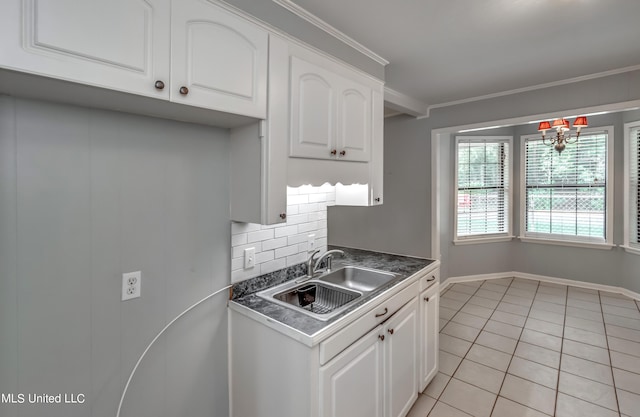 kitchen with crown molding and white cabinetry