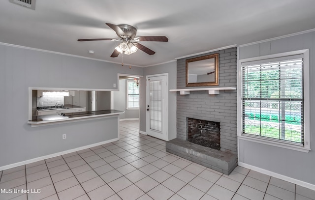 unfurnished living room with a healthy amount of sunlight, ornamental molding, light tile patterned floors, and a fireplace