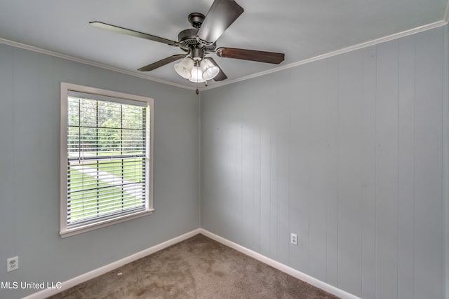 unfurnished room with crown molding, wood walls, carpet flooring, and ceiling fan