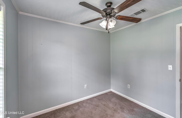 spare room with ornamental molding, carpet floors, and ceiling fan