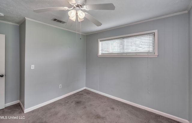 carpeted spare room featuring crown molding and ceiling fan