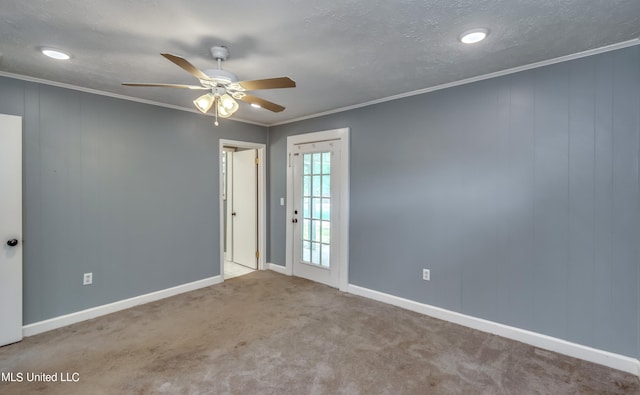 carpeted empty room with ornamental molding, a textured ceiling, and ceiling fan