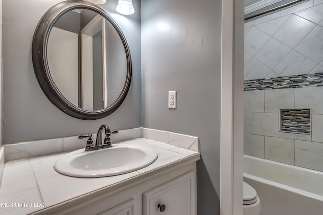 full bathroom featuring vanity, tiled shower / bath, and toilet