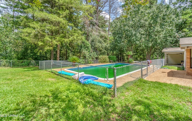 view of pool with a yard