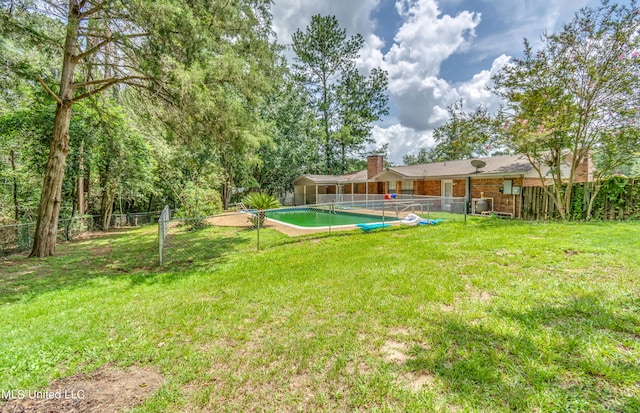 view of yard with a fenced in pool