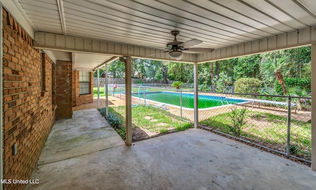 view of patio with a fenced in pool and ceiling fan