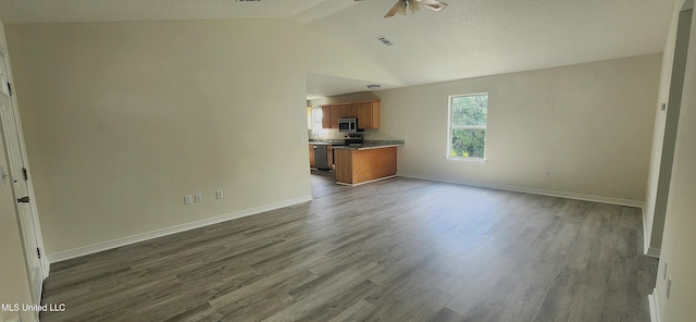 2708 Canty St, Pascagoula, MS 39567 - unfurnished living room featuring a ceiling fan, lofted ceiling, and dark wood finished floors