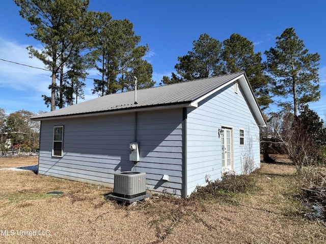 view of side of property with central air condition unit