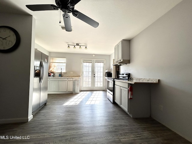 kitchen with ceiling fan, french doors, appliances with stainless steel finishes, and dark hardwood / wood-style flooring