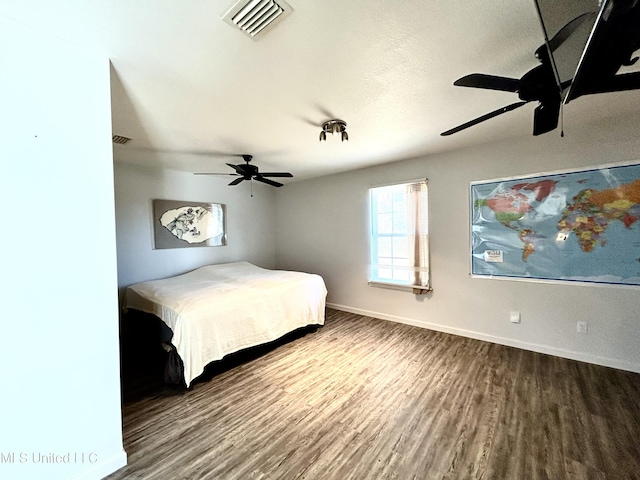 unfurnished bedroom with ceiling fan and wood-type flooring