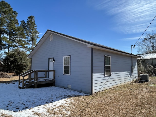 view of snowy exterior with central AC