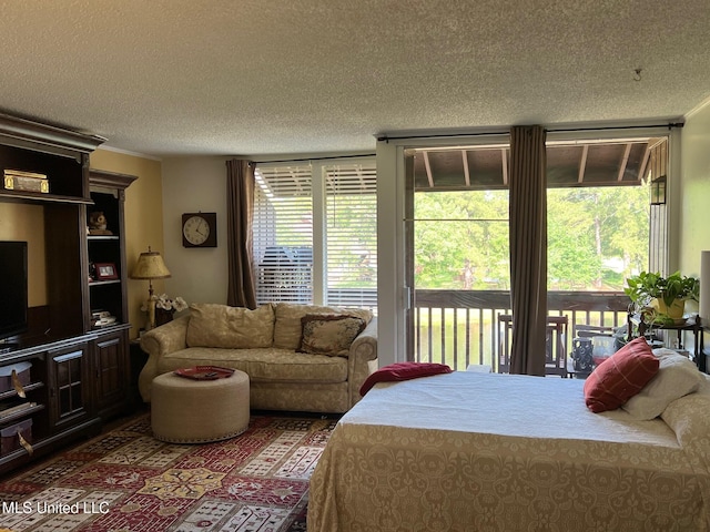 206 Lakeside Villa Unit A, Diamondhead, MS 39525 - bedroom with access to outside, a textured ceiling, and multiple windows