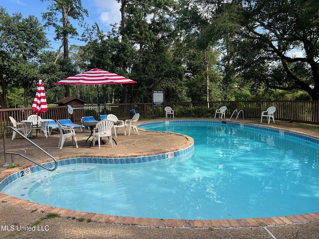 206 Lakeside Villa Unit A, Diamondhead, MS 39525 - community pool with a patio area and view of wooded area
