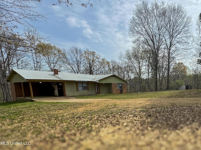 1172 Little Creek Dr, Oakland, MS 38948 - view of front facade featuring metal roof, a chimney, a front yard, driveway, and a carport